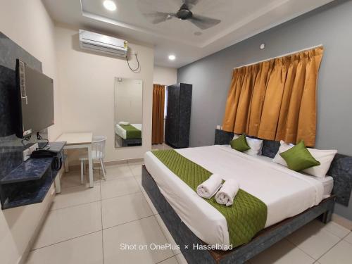 a bedroom with a bed and a desk and a television at Hotel Aerotel,Hyderabad in Shamshabad