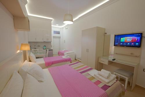 a small room with two beds and a bathroom at Hotel Mira Mare in Ksamil