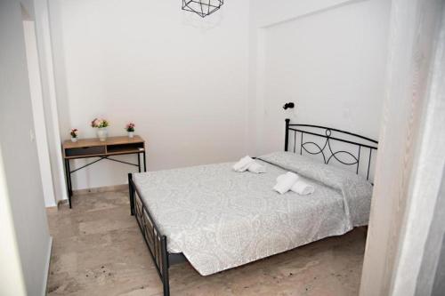 a bedroom with a bed with two pillows on it at El Verano in Kardamaina
