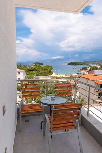 a balcony with two chairs and a table with a view at Hotel Mira Mare in Ksamil
