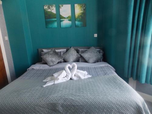 a bed with two swans made out of towels at The Celtic Pride Hotel in Blackpool