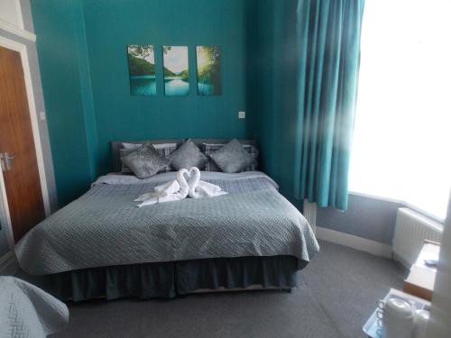 a bedroom with a bed with a swan on it at The Celtic Pride Hotel in Blackpool