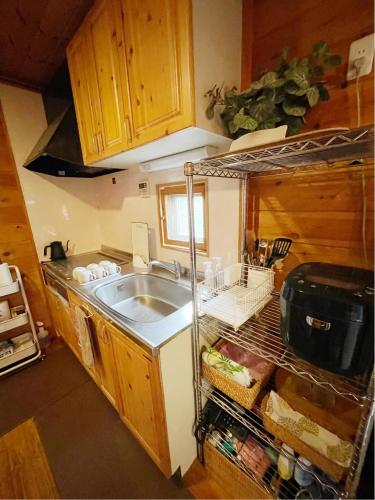 a kitchen with a sink and a counter top at 919神戸有馬 一棟貸切ログハウスMax6名1日1組限定 in Kobe