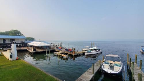 a group of boats docked at a dock on the water at Showboat Hotel in Himrod