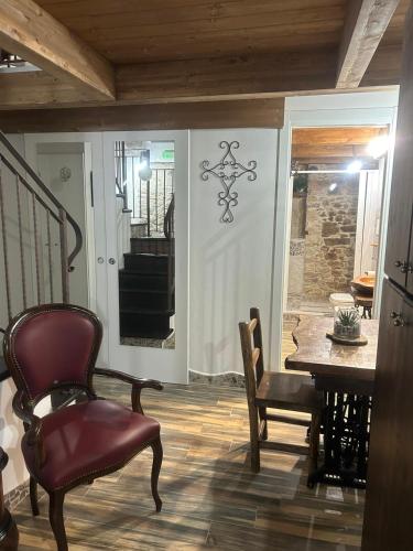 a living room with a table and a chair at Dimora Forgione B&B - Pietrelcina in Pietrelcina