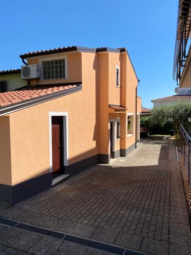 a house with a brick driveway in front of it at Apartments Nadia Umag in Umag