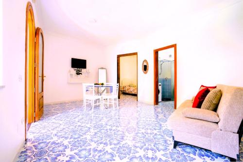a living room with a couch and a table at Villa Carrino Twin in Positano