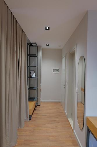 a hallway with a mirror and a shelf in a room at Hotel Ajden by Mira Mare in Ksamil