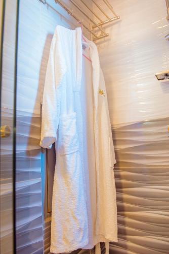 a white robe is hanging on a wall at Mountain View Hotel & Apartment in Kigali