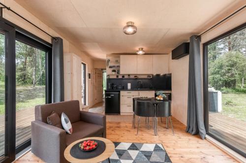 a living room and kitchen in a tiny house at Jaunjespari 1 in Batciems