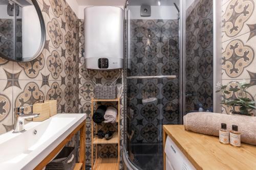 a bathroom with a shower and a sink and a mirror at Jaunjespari 1 in Batciems
