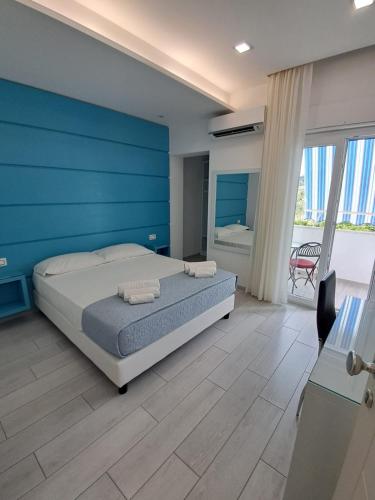 a bedroom with a bed and a blue wall at Dreams Tropea Mare "Parking Private" in Tropea