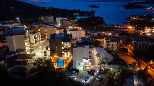 a view of a city at night with lights at Hotel Ajden by Mira Mare in Ksamil