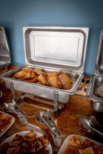 a buffet with chicken and other food on a table at Hotel Ajden by Mira Mare in Ksamil
