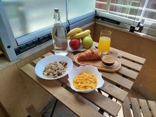 a table with two plates of food and a glass of orange juice at Happy Apartment & Free Breakfast - Mladost in Sofia