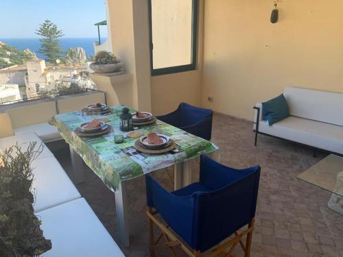 a table and chairs in a living room with a view at Captain House Luxury House in Piazzetta in Capri