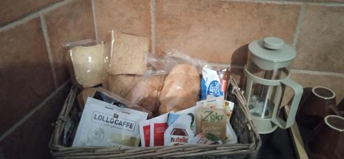 a basket on a counter with food and a coffee mug at Little Moon in Fontana Liri