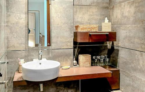 a bathroom with a white sink and a mirror at 5 Bedroom Beautiful Home In Fauverney in Fauverney
