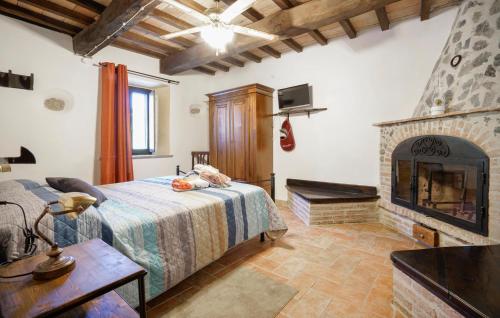 a bedroom with a bed and a fireplace at 2 Bedroom Nice Home In Stribugliano in Stribugliano