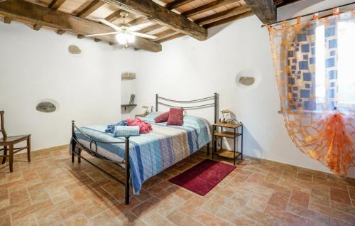 a bedroom with a bed and a large window at 2 Bedroom Nice Home In Stribugliano in Stribugliano