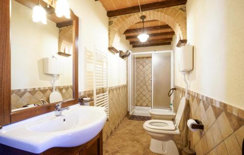 a bathroom with a sink and a toilet and a mirror at 2 Bedroom Nice Home In Stribugliano in Stribugliano