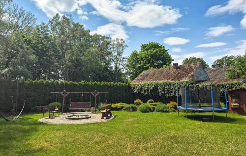a garden with a playground and a swing at 1 Bedroom Cozy Home In Wrzosowo in Wrzosowo