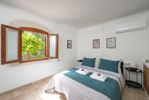 a bedroom with a large bed with two towels at liofito village house in Pemónia