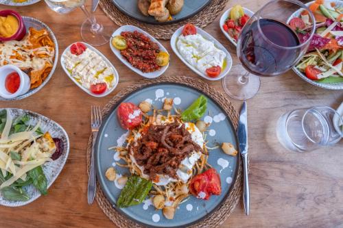 a table with plates of food and bowls of salads at Paloma Family Club in Bitez