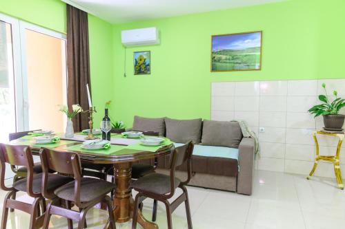 a living room with a table and a couch at Vila Misljenovic, u centru Sokobanje, na pesackoj zoni in Soko Banja