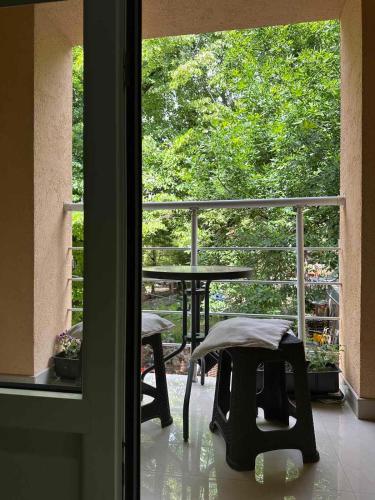 a view of a balcony with a table and bench at Vila Misljenovic, u centru Sokobanje, na pesackoj zoni in Soko Banja