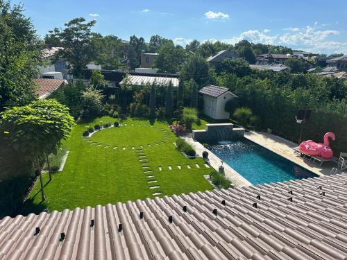 an aerial view of a backyard with a pool and a swan yard at First Apartments in Focşani