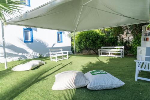 two pillows laying on the grass under a tent at Paloma Family Club in Bitez