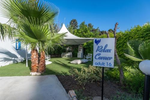 a sign in front of a tent with a palm tree at Paloma Family Club in Bitez