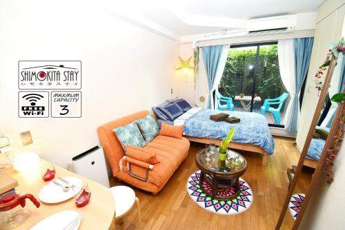 a bedroom with a bed and a couch and a table at KITAZAWA CS HOUSE / Vacation STAY 65304 in Tokyo