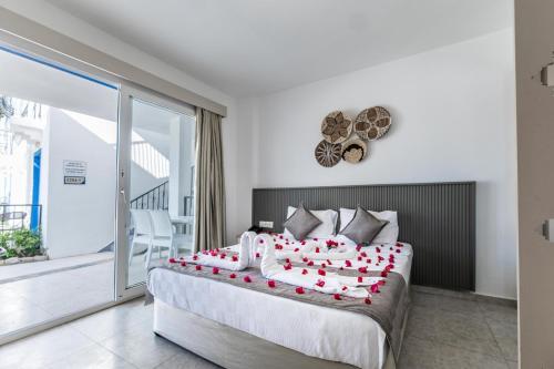 a bedroom with a large bed with red hearts on it at Paloma Family Club in Bitez