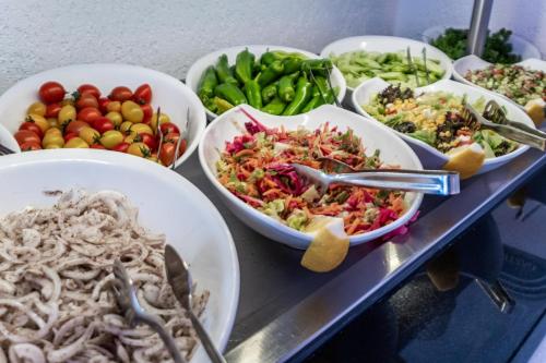 a buffet filled with bowls of different types of food at Paloma Family Club in Bitez