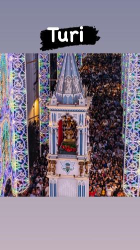 a picture of a clock tower with a crowd of people at Sweet home-Casa Di Bari in Turi