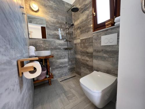 a bathroom with a toilet and a sink at First Eco-Villa in Polis Chrysochous