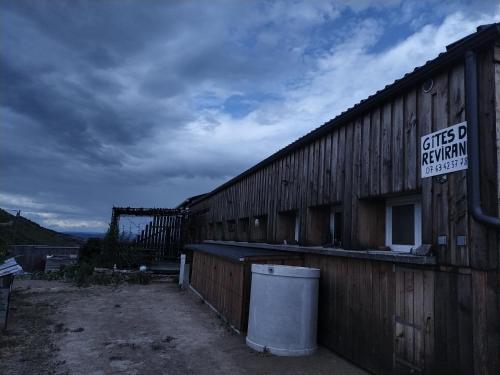 a building with a sign on the side of it at Gîtes de Revirand in Sarras
