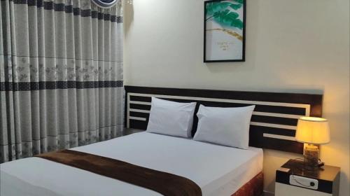 เตียงในห้องที่ H. V Hotel Bandara Gorontalo