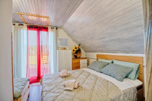 a bedroom with a large bed with red curtains at Apartment Pri Braceku - Odmor u prirodi - Nature Retreat & Relaxation in Samobor