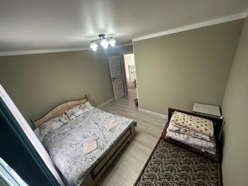a small bedroom with two beds and a rug at Aida guest house in Arkit