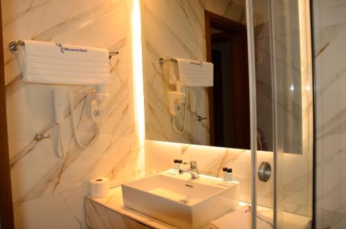 a bathroom with a sink and a mirror at Odysseus Hotel in Paleokastritsa