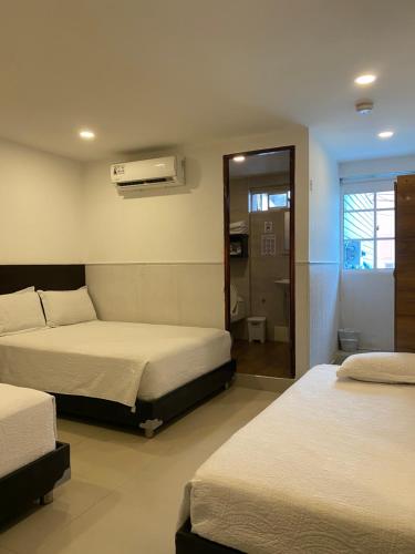 a hotel room with two beds and a bathroom at Apartahotel Marbella in San Andrés