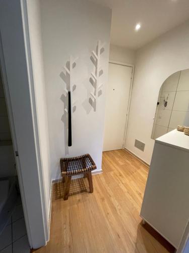 a kitchen with white walls and a wooden floor at Appartamento La Torretta in Locarno