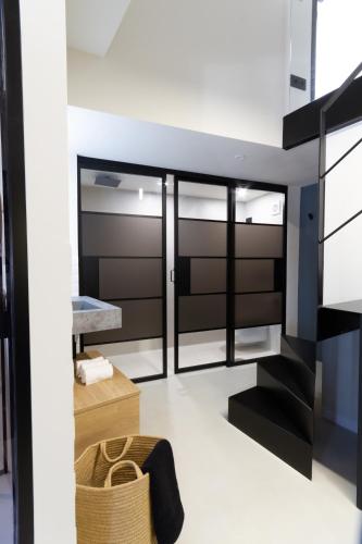 a modern bedroom with black and white furniture at La Casa del Conde - Un alojamiento único en Écija in Écija