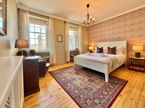 a bedroom with a bed and a brick wall at St Johns Jailhouse by the Castle in Stirling