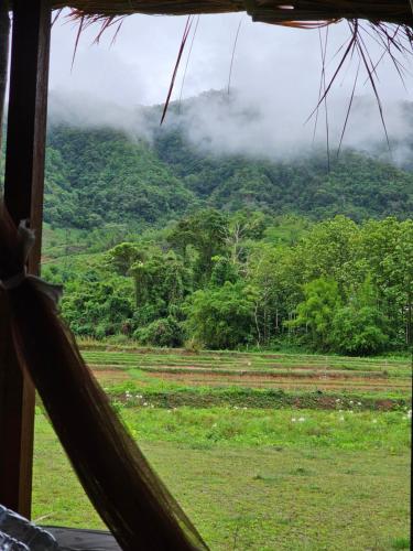 a view of a mountain from a hammock at PANAKLUEA Cottage & Crafts - พนาเกลือ in Ban Kham