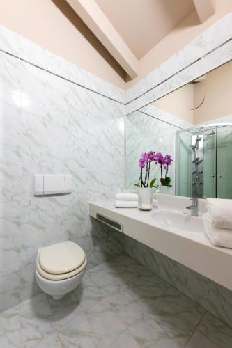 a bathroom with a toilet and a sink at Hotel Hannover in Grado