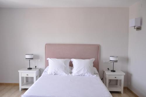 a bedroom with a white bed with two night stands at Boutique Hotel Mamabels in Mojácar